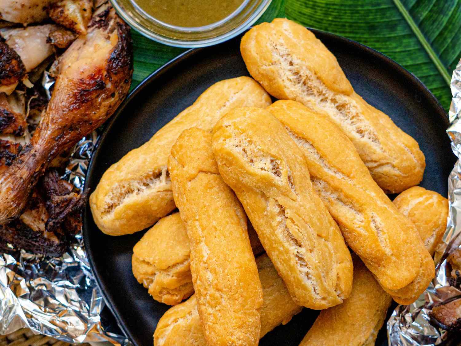 <p> Festival is a type of fried dough that's slightly sweet and crispy on the outside while soft on the inside. Made from cornmeal and flour, festival is often served alongside jerk chicken, fried fish, or ackee and saltfish. Its slightly sweet flavor and satisfying texture make it a popular accompaniment to many Jamaican dishes. </p> :: Serious Eats