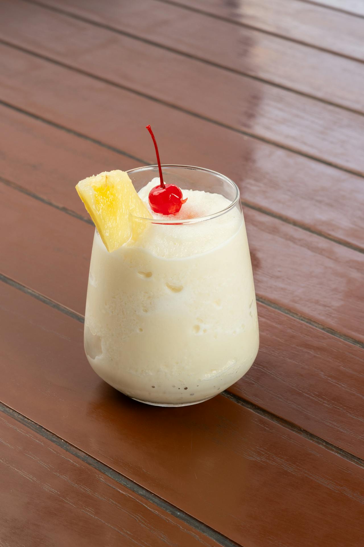 <ol> <li> In a shaker, combine pineapple juice and coconut cream, shaking well to mix. </li> <li> Fill a glass with ice and pour the pineapple-coconut mixture over the ice. </li> <li> Top with club soda for a bubbly finish. </li> <li> Garnish with a pineapple wedge and a maraschino cherry. </li> </ol> :: Pexels