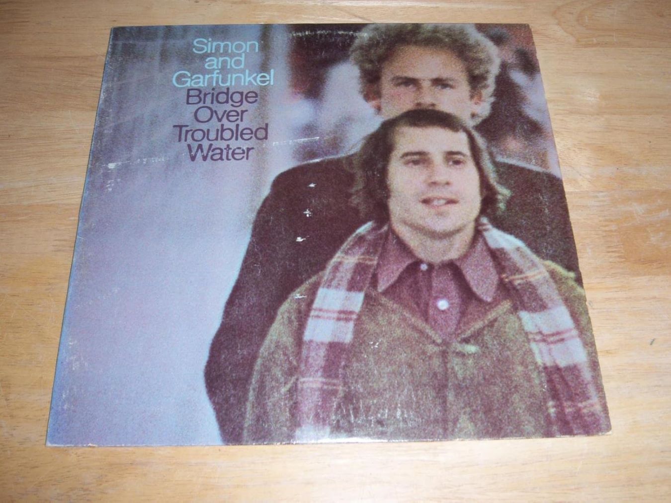 <p> Bridge Over Troubled Water is the final studio album by Simon and Garfunkel and is often considered their best work. The album features beautiful harmonies and heartfelt lyrics, with standout tracks like "The Sound of Silence," "Bridge Over Troubled Water," and "Cecilia." The blend of folk and rock elements creates a timeless sound that has resonated with audiences for generations. This album not only showcases the duo's incredible talent but also captures the emotional depth of their music, making it a must-have for any music enthusiast. The lyrical storytelling and intricate arrangements showcase the duo's artistry at its peak. </p> :: Max Vandaag