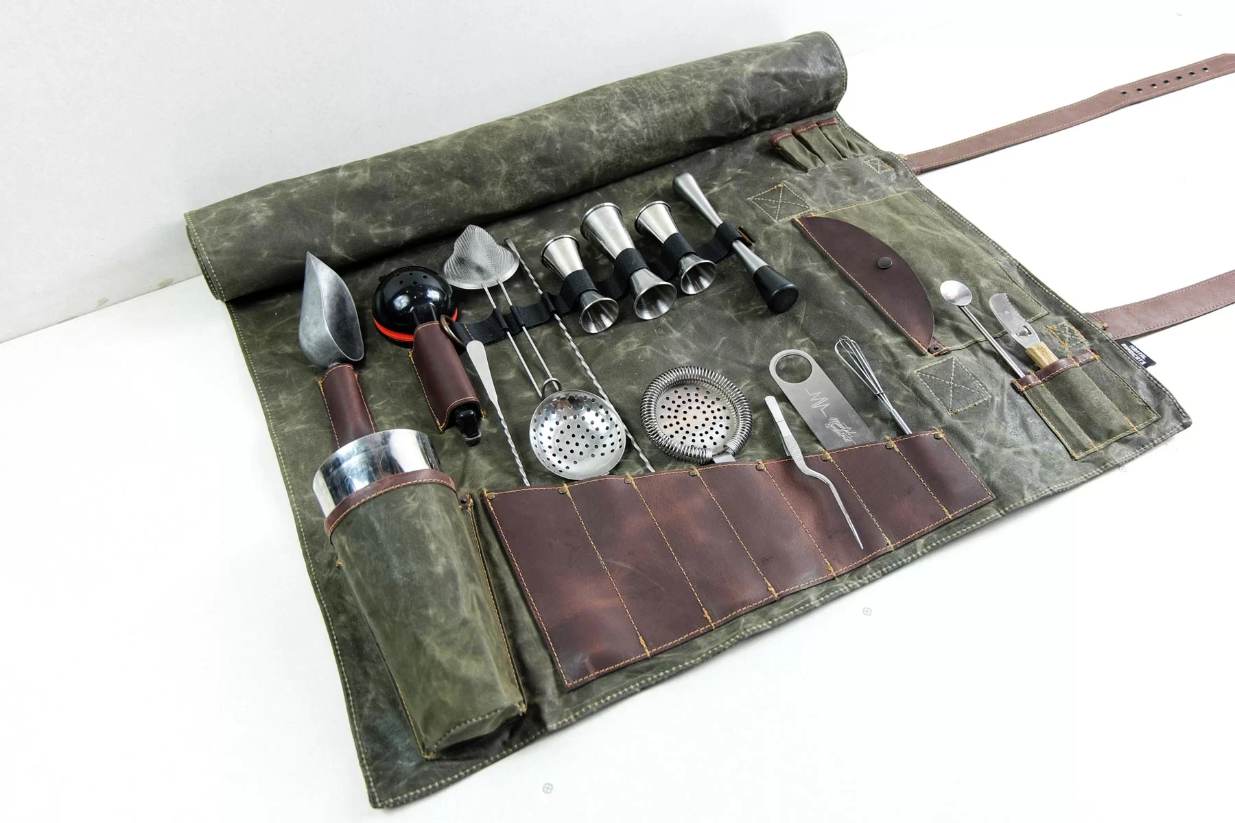 <p> For the bartender on the go, a bartender’s tool roll is a practical and stylish gift. These rolls are designed to hold all the essential tools needed for crafting cocktails, such as a muddler, jigger, strainer, and bar spoon. Made from durable materials like leather or canvas, these tool rolls keep everything organized and easily accessible. Whether they’re hosting a gathering, attending a party, or traveling to a cocktail competition, a tool roll ensures they have all their tools at hand in one compact, portable package. It’s a perfect gift for anyone who enjoys mixing drinks in a variety of settings. </p> :: Mental Syndicate