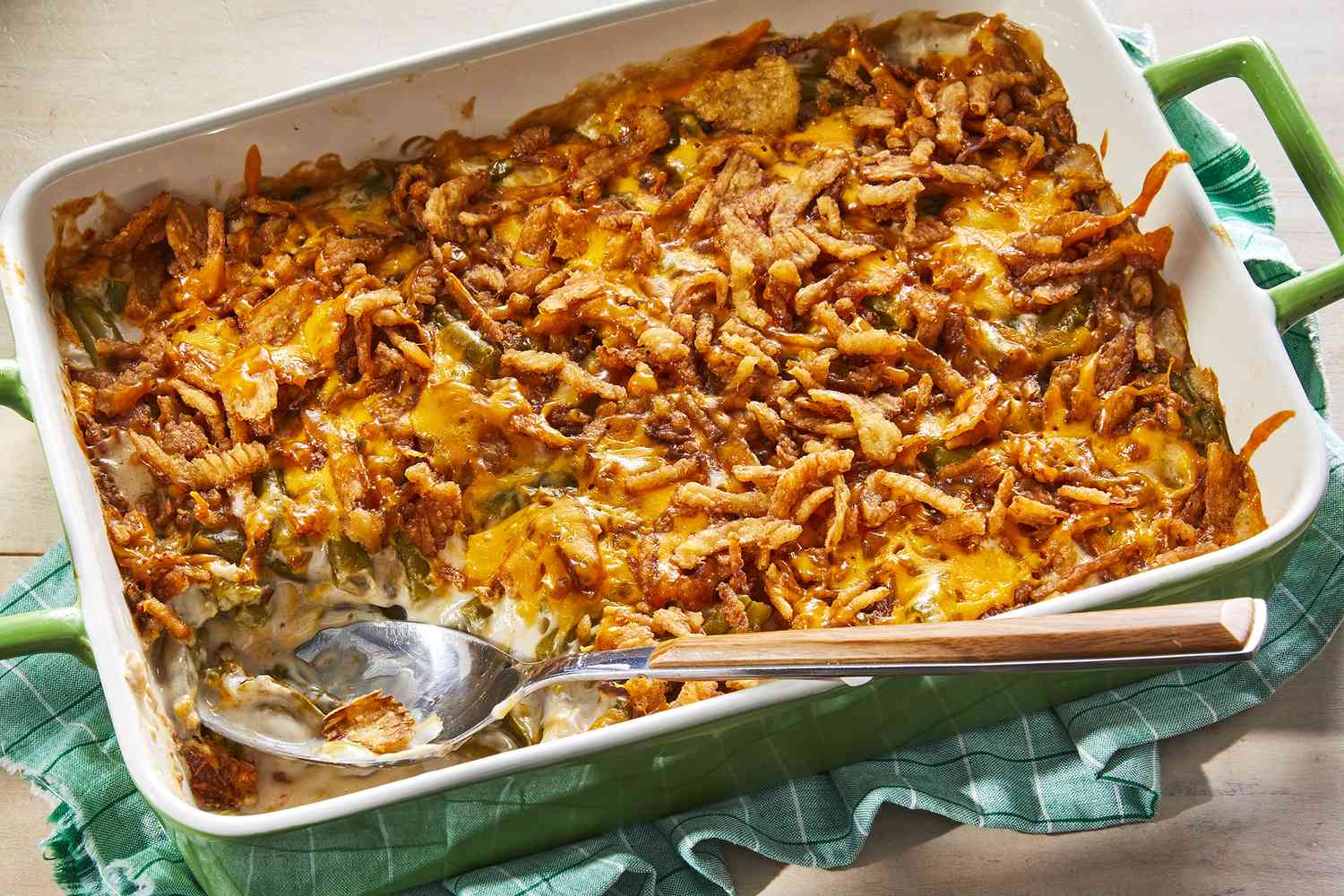 <p> This green bean casserole puts a fresh spin on the classic dish. Featuring crisp green beans, a creamy homemade mushroom sauce, and plenty of melted cheddar cheese, it is topped with crispy fried onions for a satisfying crunch. This side dish is sure to be a hit at your table. </p> :: Dotdash Meredith Food Studios / AllRecipes