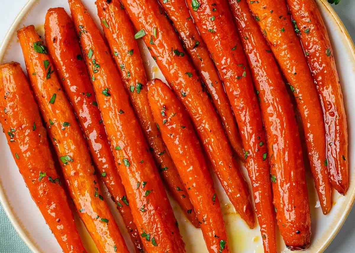 <p> These honey-glazed carrots are the perfect mix of sweet and savory. Roasted to caramelized perfection, they are coated with a glaze made from honey, brown sugar, and a hint of cinnamon. This colorful side dish adds a burst of flavor to your plate and balances out the richness of the main course. </p> :: Ayeh Manfre / cookingwithayeh.com