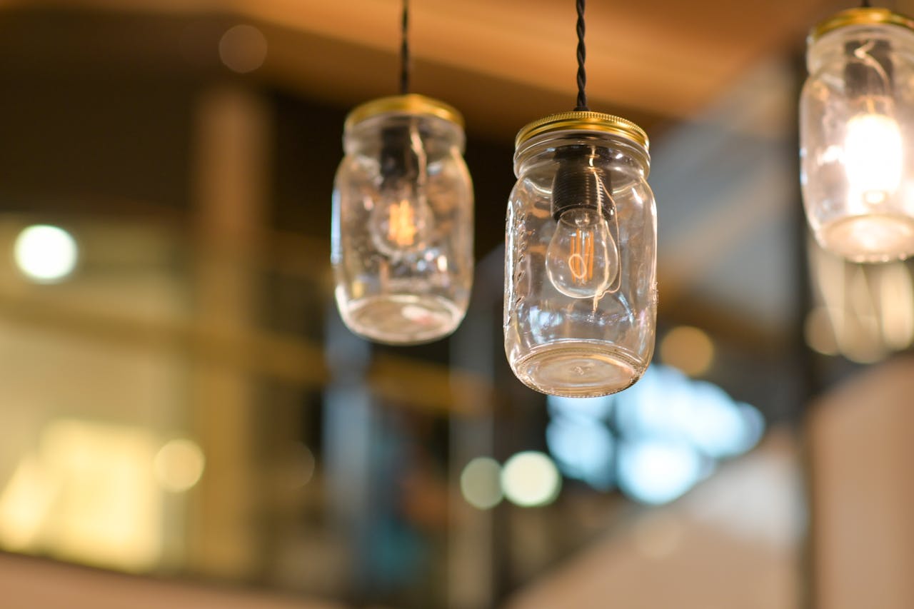 <p> Mason jar lanterns are a simple yet charming way to illuminate your home with the warm glow of fall. To get started, gather a few mason jars, tea lights or LED candles, and some fall-themed decorations like twine, dried leaves, or mini pinecones. Begin by placing a tea light inside each jar, then decorate the outside using Mod Podge to attach dried leaves. When the candles are lit, the leaves give off a beautiful stained-glass effect. These lanterns can be used on your porch, dining table, or mantle, adding a cozy glow to any space. </p> :: Pexels