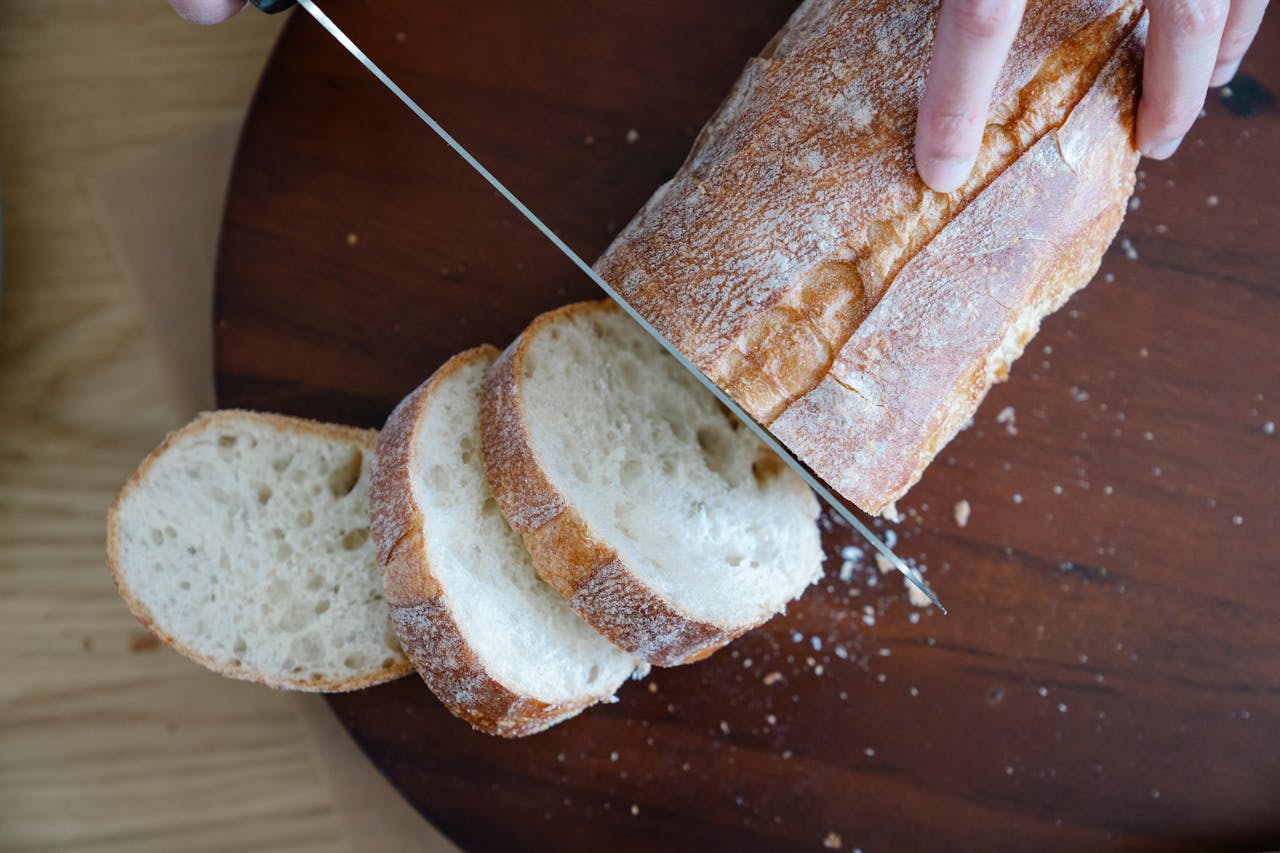 <p> While it’s tempting to slice into your freshly baked loaf as soon as it comes out of the oven, it’s important to let it cool down first. Cutting into the bread while it’s still hot will result in a gummy texture, as the interior hasn’t had time to fully set. Let your bread cool for at least 30 minutes on a wire rack before slicing. This cooling period allows the bread to firm up and develop its full flavor. Plus, it’ll make the slicing process much easier. </p> :: Pexels