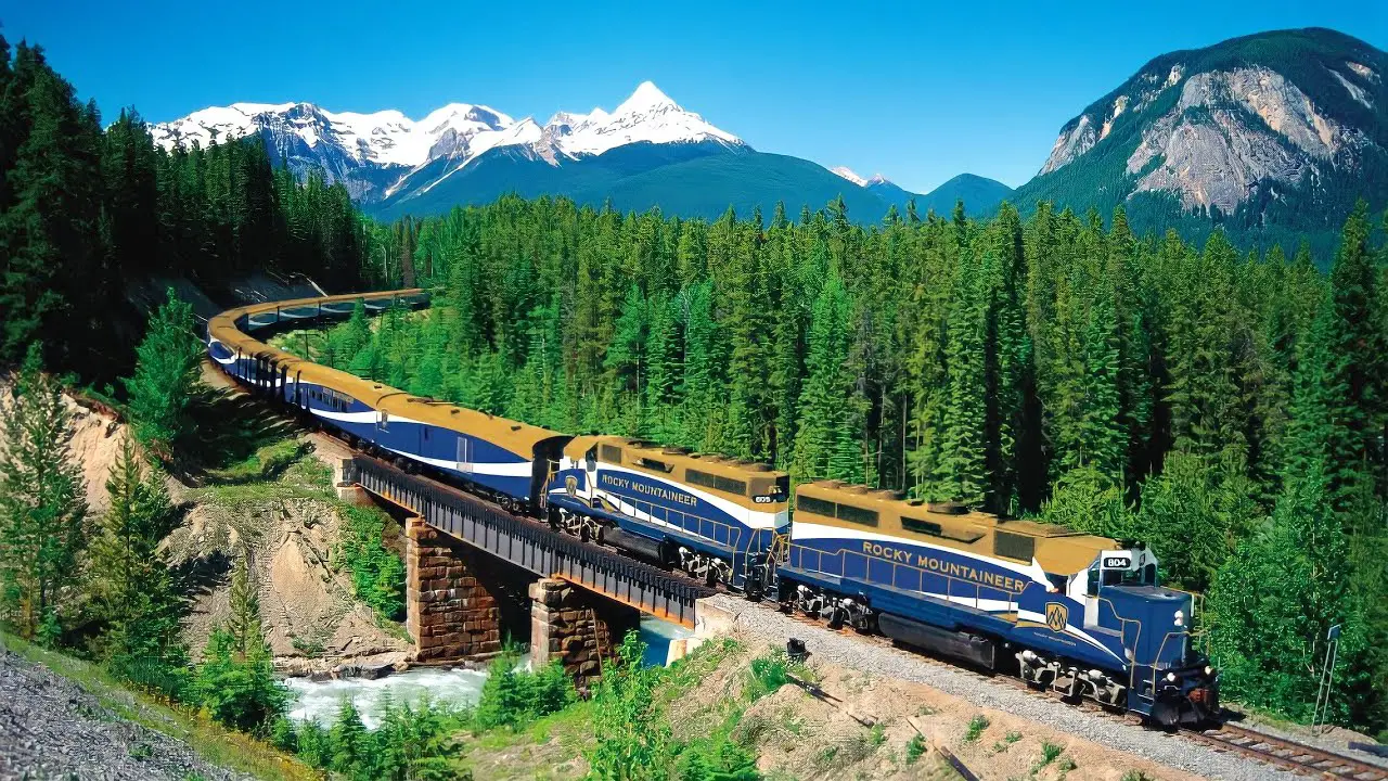 <p> The Rocky Mountaineer is the ultimate way to explore the grandeu of the Canadian Rockies. This luxury train features multiple routes, with the “First Passage to the West” being the most famous. From turquoise rivers and dense forests to snow-dusted peaks, the views are as dramatic as they are diverse. With gourmet meals and attentive service on board, you’ll feel like royalty while soaking in the natural wonders outside. Wildlife sightings, including bears and eagles, add to the thrill. </p> :: Absolute Break YouTube Channel