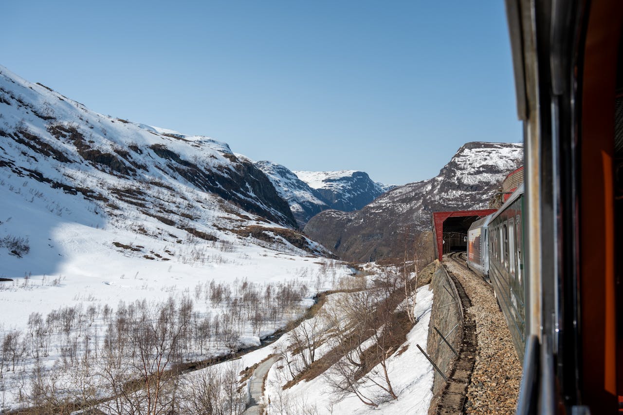 <p> The Flam Railway offers one of the most stunning short train rides in the world. Starting in the small Norwegian village of Flam, this route climbs through dramatic mountain terrain, passing waterfalls, verdant valleys, and charming Nordic homes. The journey includes a stop at the powerful Kjosfossen waterfall, where you can step out and marvel at its raw beauty. Though only an hour long, this train ride packs more scenery than many longer trips. </p> :: Pexels