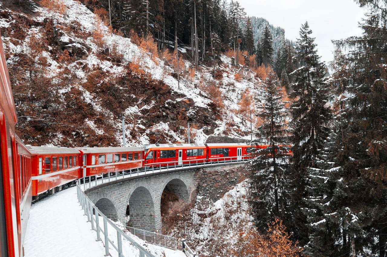 <p> Known as the “slowest express train in the world,” the Glacier Express delivers an experience that prioritizes beauty over speed. This iconic journey takes you across the Swiss Alps, connecting the resort towns of Zermatt and St. Moritz. Over eight hours, you’ll glide past verdant valleys, picturesque villages, and stunning mountain passes like the Oberalp Pass. The train’s large panoramic windows ensure every view is spectacular, making it a must for those seeking awe-inspiring scenery. </p> :: Pexels