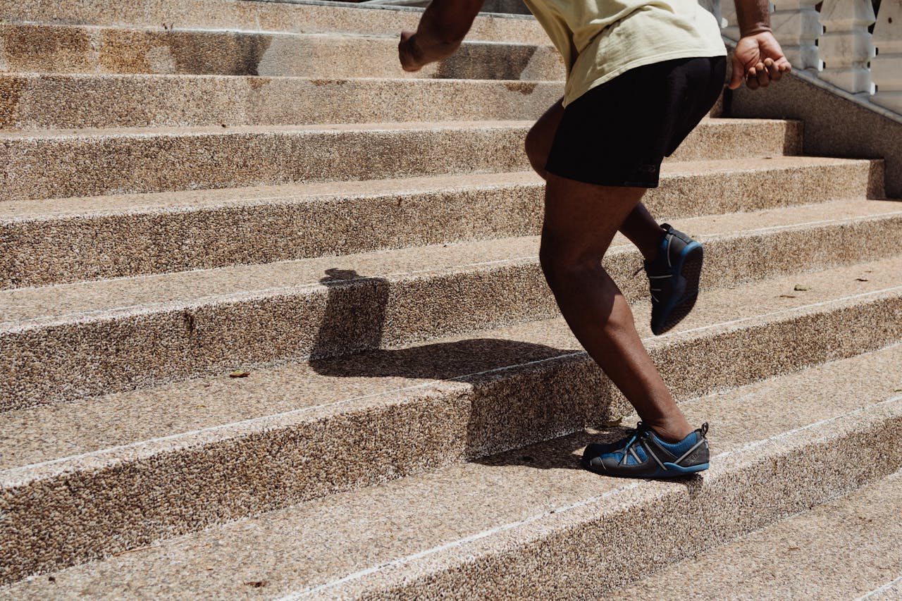 <p> If you’re looking for a simple yet effective way to stay active throughout the day, taking the stairs is a great option. Climbing stairs is a weight-bearing exercise that strengthens your legs, tones your glutes, and improves cardiovascular health. It’s also an activity that can be easily incorporated into your daily routine. Instead of taking the elevator, opt for the stairs whenever possible – whether at work, at home, or when out running errands. To make it more challenging, try increasing the number of flights you climb each day or incorporate stair sprints for a high-intensity workout. It’s a small change that can have a big impact on your fitness. If you have access to a set of stairs at home or work, make it a habit to take a few extra trips up and down each day. You can even challenge yourself to see how many flights you can climb in a set amount of time. It’s a great way to get your heart rate up and improve lower body strength without the need for any special equipment. </p> :: Pexels