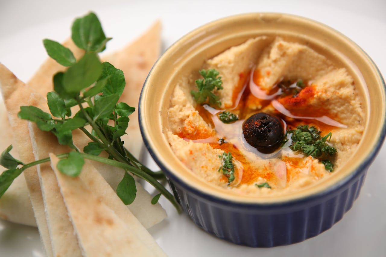 <p> Hummus, made from chickpeas, tahini, olive oil, and spices, is a nutrient-rich dip that is high in fiber, protein, and healthy fats. It is a versatile spread that pairs well with vegetables, whole-grain crackers, or sandwiches. Store-bought hummus can be just as healthy as homemade, so check the label for minimal additives. Hummus is also an excellent source of plant-based protein, making it a great option for vegetarians. Experiment with different flavors like roasted red pepper or garlic to keep your snacks exciting and flavorful. </p> :: Pexels