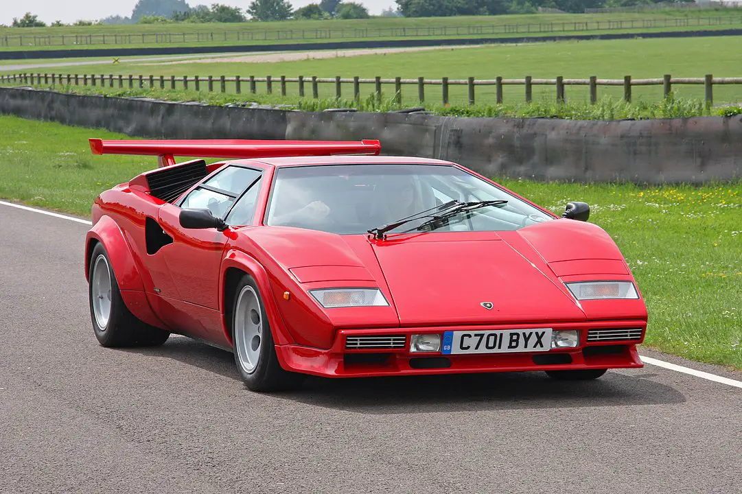 <p>The Countach’s radical wedge shape and scissor doors set a new standard for supercar design. Its name comes from a Piedmontese dialect word meaning “wow” or “astonishment,” perfectly capturing its impact. The car’s design was so influential that it remained in production for over 16 years with only minor updates.</p> ::Brian Snelson