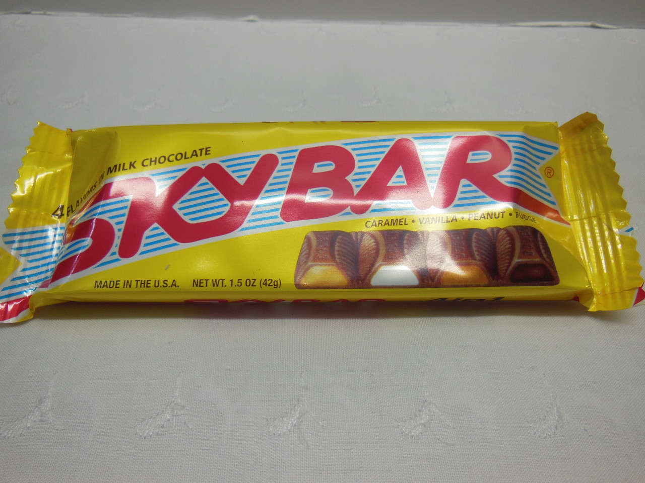 <p>Introduced in 1938, Sky Bar features four different fillings—caramel, vanilla, peanut, and fudge—each encased in a milk chocolate shell. It’s a unique candy that combines multiple flavors in one bar.</p> ::boydsretrocandy