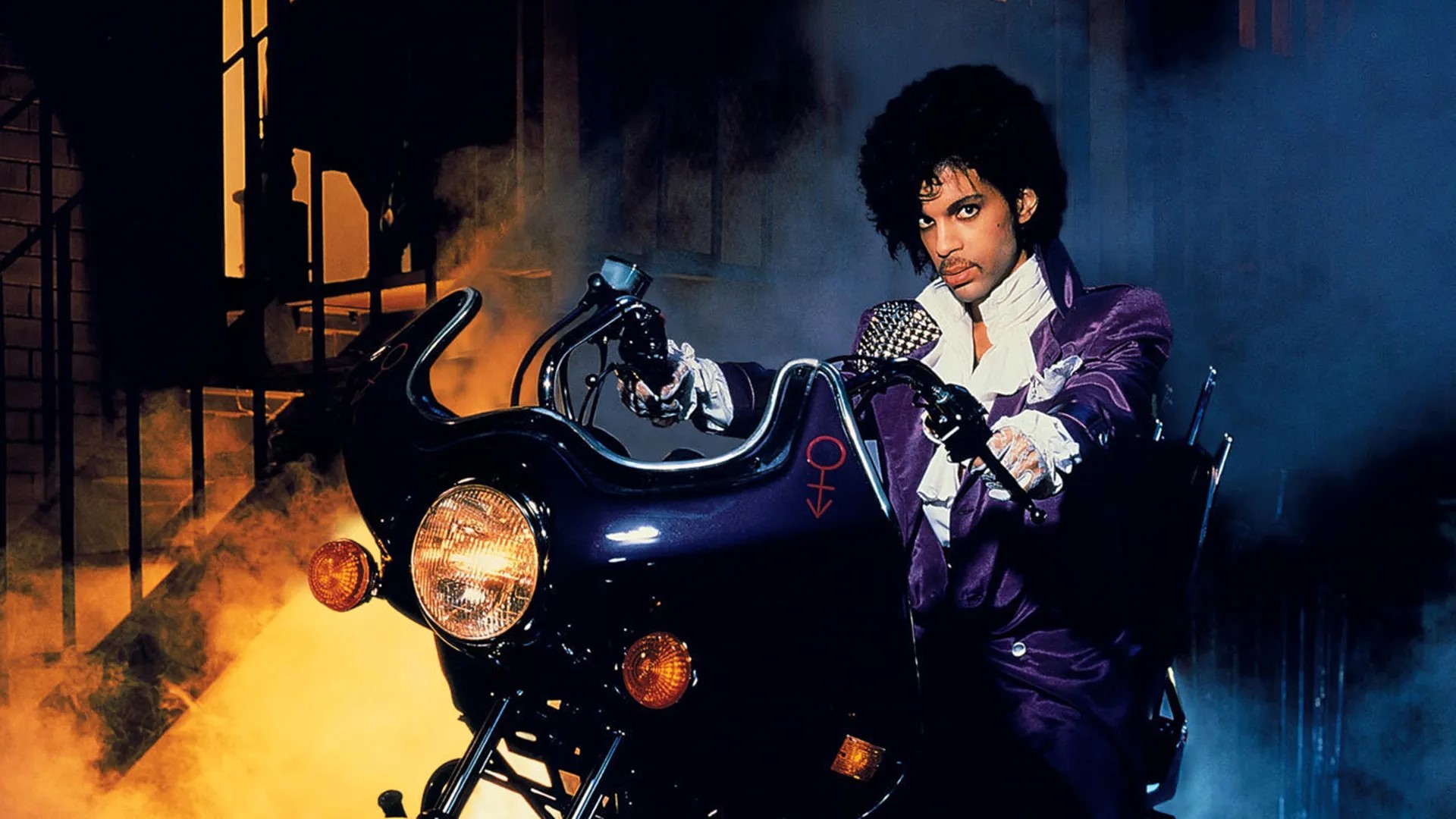 <p>Prince’s magnum opus, Purple Rain, blends rock, R andB, and pop in a dazzling display of musicianship. The title track, along with “When Doves Cry” and “Let’s Go Crazy,” showcase his genius and charismatic presence. The album’s fusion of genres set new standards for pop and rock music. Purple Rain was also the soundtrack to Prince’s semi-autobiographical film of the same name, which won an Academy Award for Best Original Song Score.</p> ::Warner Bros. Discovery